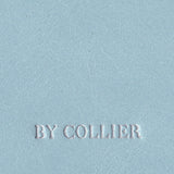 Light blue leather surface with 'BY COLLIER' embossed in white.